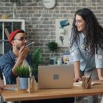 Young professional using Bumble BFF and Timeleft apps on phone in a coffee shop