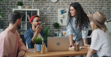 Young professional using Bumble BFF and Timeleft apps on phone in a coffee shop